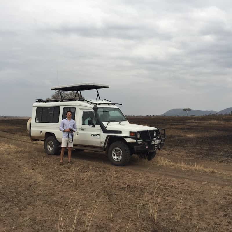 Client standing next to game drive vehicle